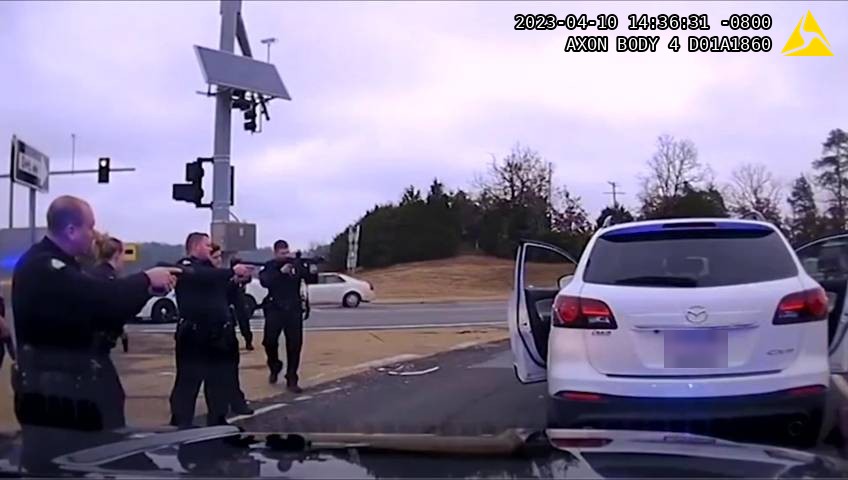 Body camera footage of officers with weapons drawn at a roadside vehicle stop, timestamped by Axon Body 4